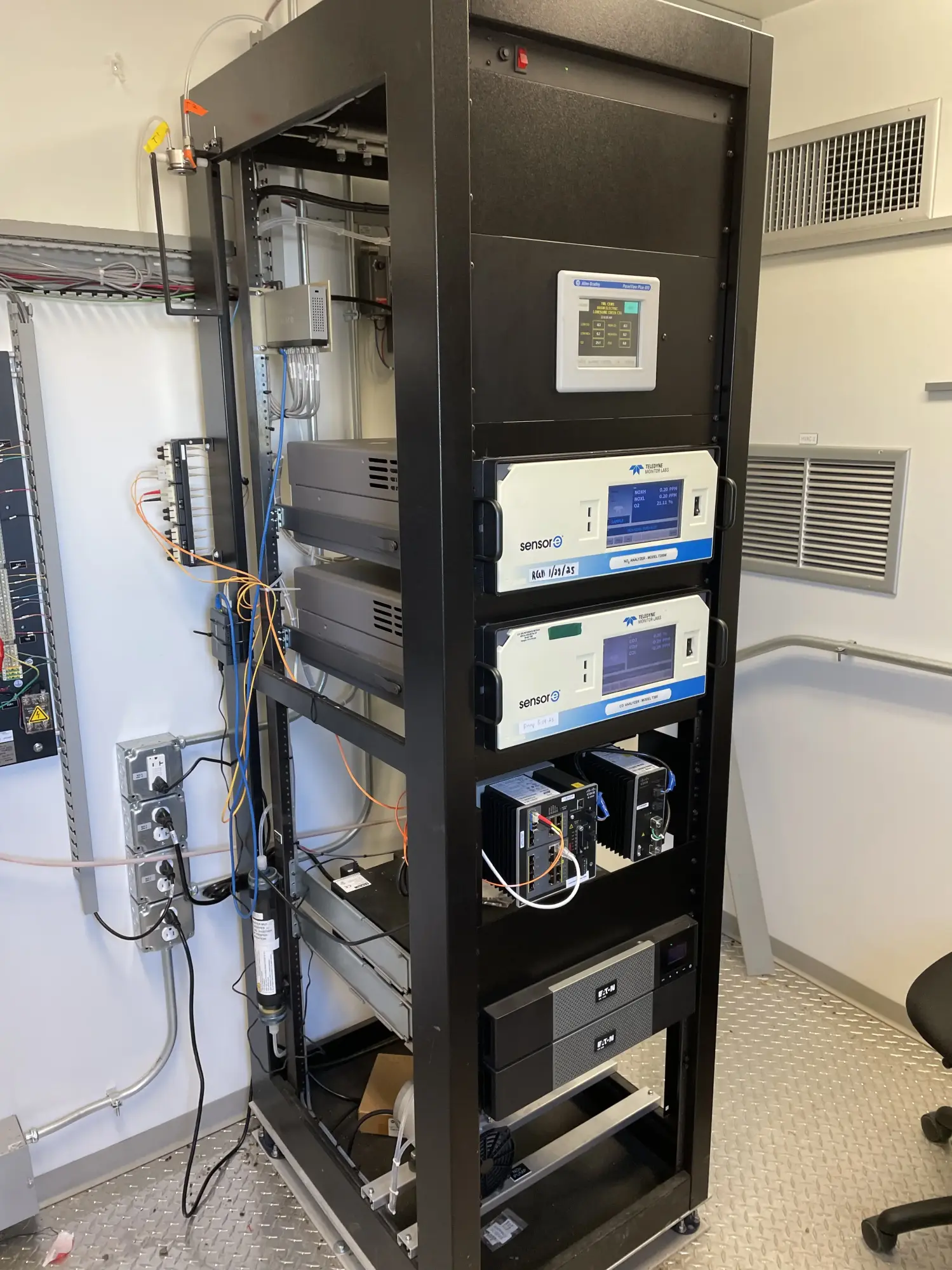 CEMS analyzer rack with gas monitors and calibration equipment