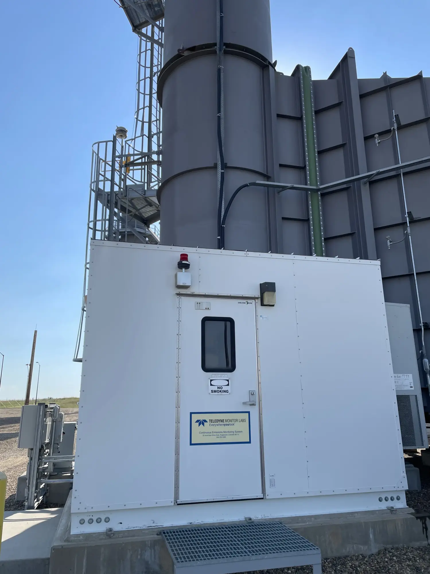 Industrial emissions stack with monitoring equipment