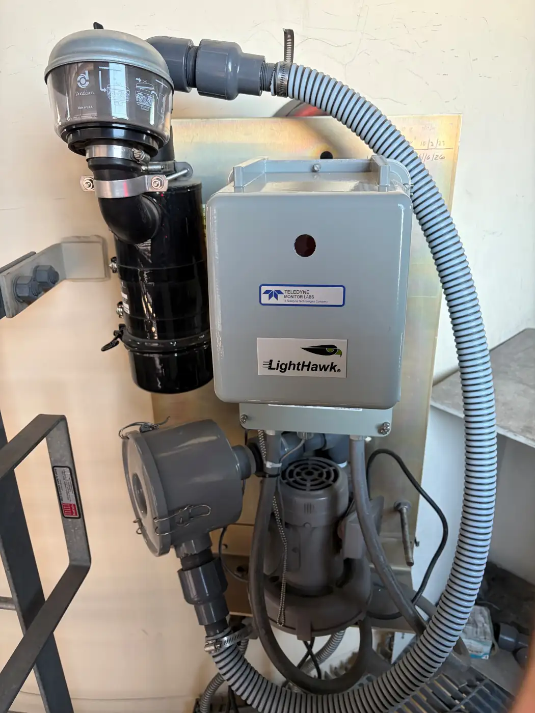 Teledyne LightHawk opacity monitor installed on a stack with purge air blower and sample conditioning